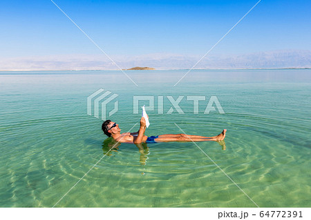 Man relaxing in nature. View of Dead Sea. Man relaxing in nature. View of Dead Sea. 64772391
