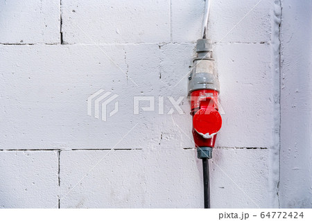 electrical three-phase connection to the white wall from the building blocks, background 64772424