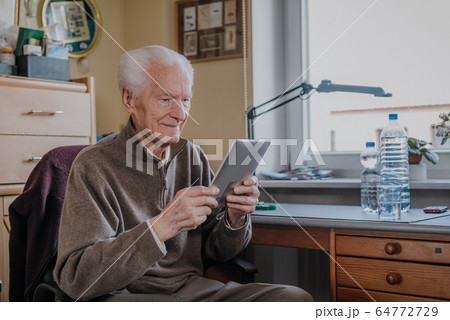 Positive Senior using Digital Tablet Positive Senior using Digital Tablet 64772729
