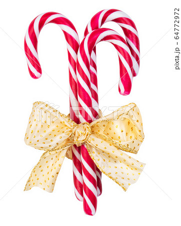 Red striped caramel sticks tied with a golden bow 64772972