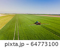 Agriculture Tractor Working in Field 64773100