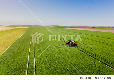 Agriculture Tractor Working in Field 64773100