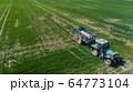 Agriculture Tractor Working in Field Spraying Herbicides 64773104