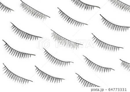 Black false eyelashes isolated on white background. Flat lay 64773331