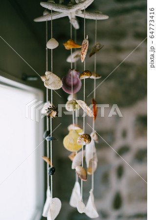 Music wind shells. Decoration in the interior of the apartment in the sea theme of shells 64773416