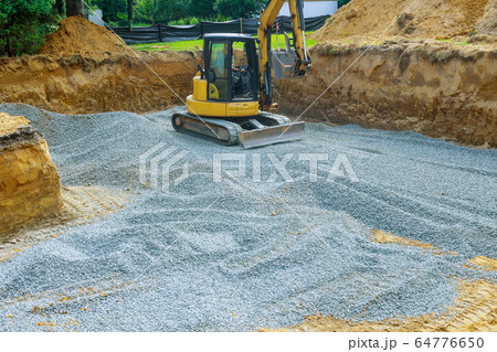 Excavator digging bucket scooping gravel from a Excavator digging bucket scooping gravel from a 64776650