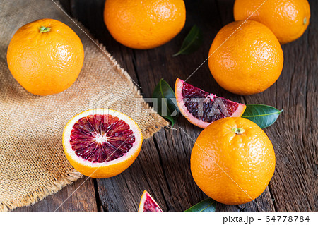 Sliced Sicilian Blood oranges fruits over old dark 64778784
