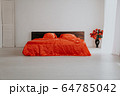 the Interior of the white room with a bed with red 64785042