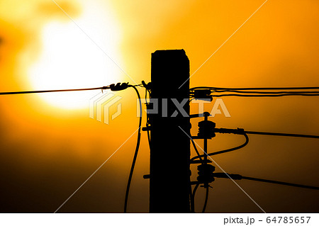 Sunset and Eletricity line and electricity post 64785657