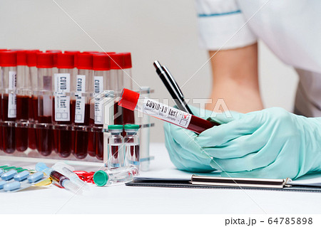 woman docxtor working with blood test tubes woman docxtor working with blood test tubes 64785898