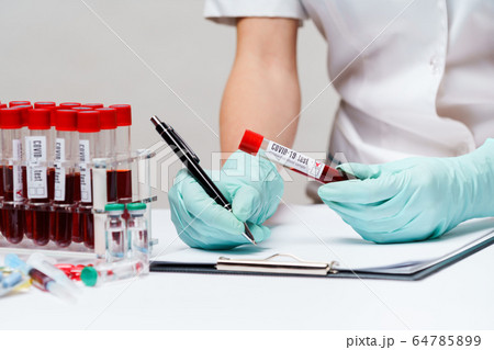 woman docxtor working with blood test tubes woman docxtor working with blood test tubes 64785899