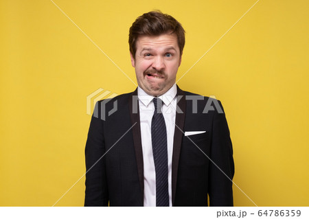 Portrait of a pensive young man in suit 64786359