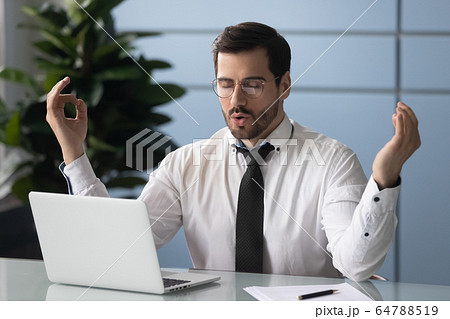 Satisfied businessman relaxing, meditating in yoga pose breathing exercises. Satisfied businessman relaxing, meditating in yoga pose breathing exercises. 64788519
