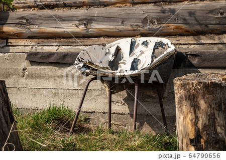 Very old chair on the backyard 64790656
