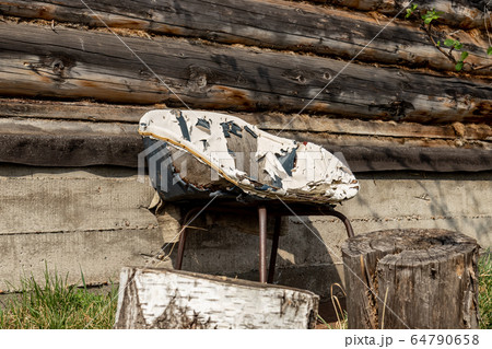 Very old chair on the backyard 64790658