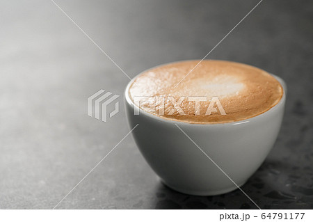 Fresh cappuccino in white cup on concrete background Fresh cappuccino in white cup on concrete background 64791177