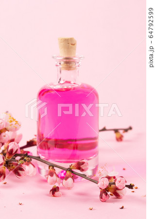 Perfume bottle and a branch of blooming apricots 64792599