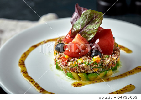 Delicious quinoa salad with avocado and tomatoes. Macro. Delicious quinoa salad with avocado and tomatoes. Macro. 64793069
