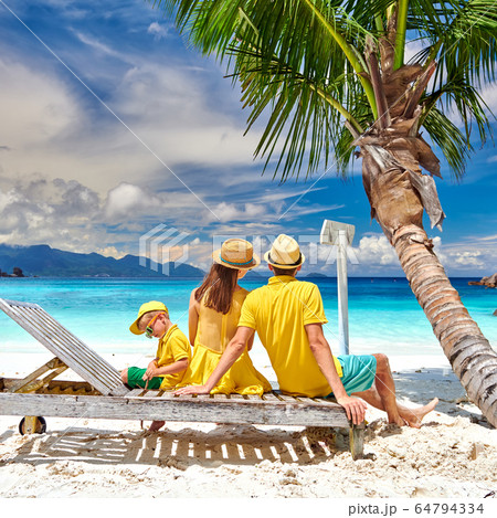 Family with three year old boy on beach. 64794334