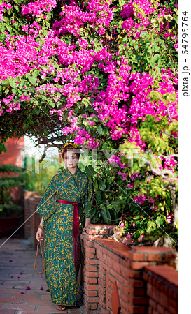 Beautiful woman in Geisha kimono in a garden Beautiful woman in Geisha kimono in a garden 64795764
