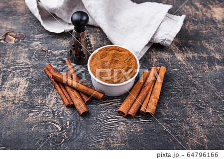 Cinnamon sticks and powder on black Cinnamon sticks and powder on black 64796166