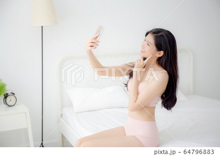 pretty young Asian teenage girl in colorful underwear, looking seriously,  Stock Photo, Picture And Rights Managed Image. Pic. BWI-BS107486