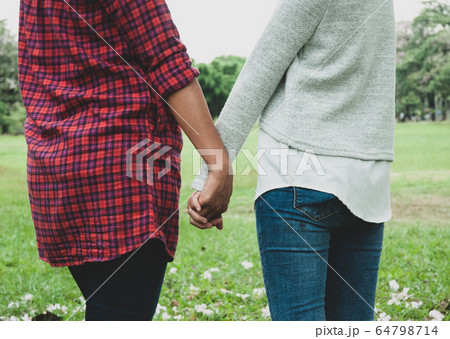 Beautiful family mother and daughter are walking in summer at the garden park. Beautiful family mother and daughter are walking in summer at the garden park. 64798714