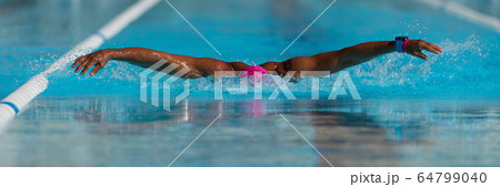 Swim competition swimmer athlete doing butterfly stroke in swimming pool 64799040