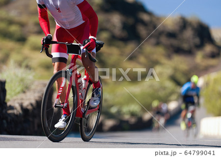 Cycling competition,cyclist athletes riding a race, climbing up a hill on a bicycle 64799041