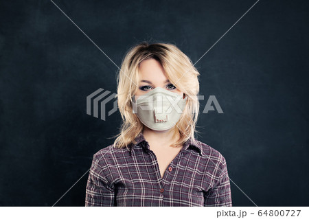 Woman in medical face mask on black background 64800727