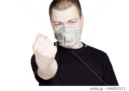 Fist of man in medical face mask on white Fist of man in medical face mask on white 64801011