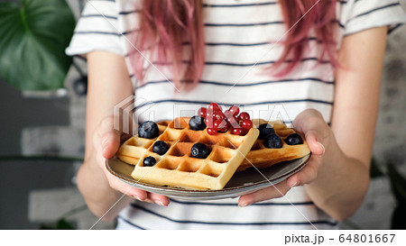 Plate of waffles in hands Plate of waffles in hands 64801667