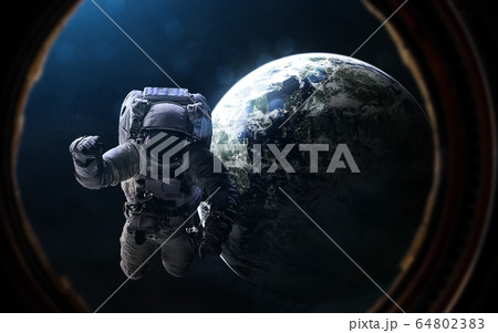 Astronaut and exoplanet in porthole of space ship. Deep space in rays of blue star Astronaut and exoplanet in porthole of space ship. Deep space in rays of blue star 64802383