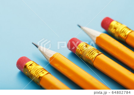 Orange pencils with an eraser on a blue Orange pencils with an eraser on a blue 64802784