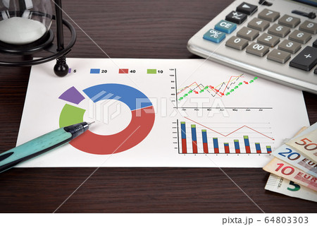 Drawing financial charts and report on a paper. Success and startup concept. Close up 64803303