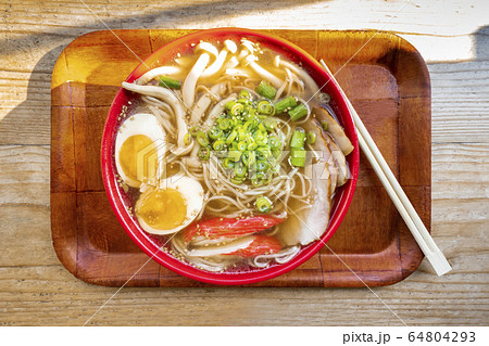 Tonkotsu ramen close-up, shot above, with eggs, scallions and mushrooams, with chopsticks on a tray 64804293