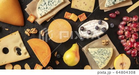 Cheese flat lay panorama. Many different cheeses, shot from above on a dark background Cheese flat lay panorama. Many different cheeses, shot from above on a dark background 64804308