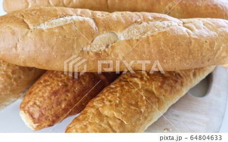 Fresh bread, french baton, tiger bread and small baguettes close up, with shallow depth of focus 64804633