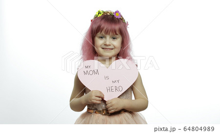 Child girl princess holds pink paper heart with text about mother. Mother's day 64804989