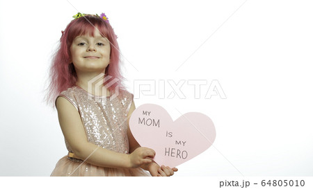 Child girl princess holds pink paper heart with text about mother. Mother's day 64805010