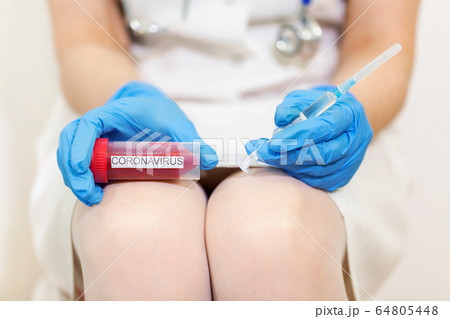 Woman Doctor holding Coronavirus COVID-19 Infected Blood Sample and syringe Woman Doctor holding Coronavirus COVID-19 Infected Blood Sample and syringe 64805448