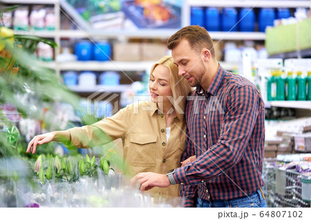 beautiful married couple came in market to buy plants 64807102