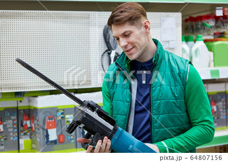 confident salesman try new commodity in store confident salesman try new commodity in store 64807156