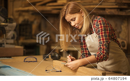 beautiful caucasian woman carpenter deals with handicraft 64807194
