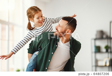 Father and little daughter having fun at home. 64807206