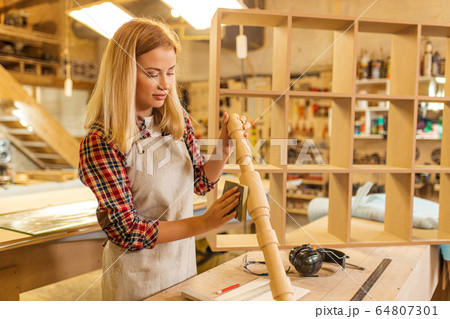 skillful carpenter woman grinding wood skillful carpenter woman grinding wood 64807301