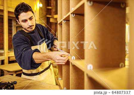 carpenter use tape-line during work carpenter use tape-line during work 64807337