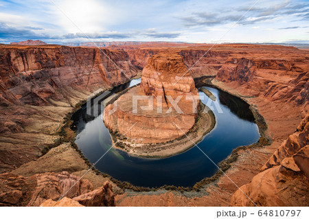 Horseshoe bend canyon giant stone loop panoramic view, looking down at Colorado river bend and red rock canyon, standing walls on the edge. Horseshoe bend canyon giant stone loop panoramic view, looking down at Colorado river bend and red rock canyon, standing walls on the edge. 64810797