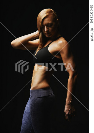 Portrait of a sports woman, on a dark background, sports motivation, copy space. 64810949