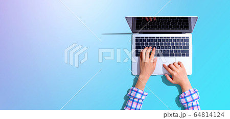 Person using a laptop computer Person using a laptop computer 64814124